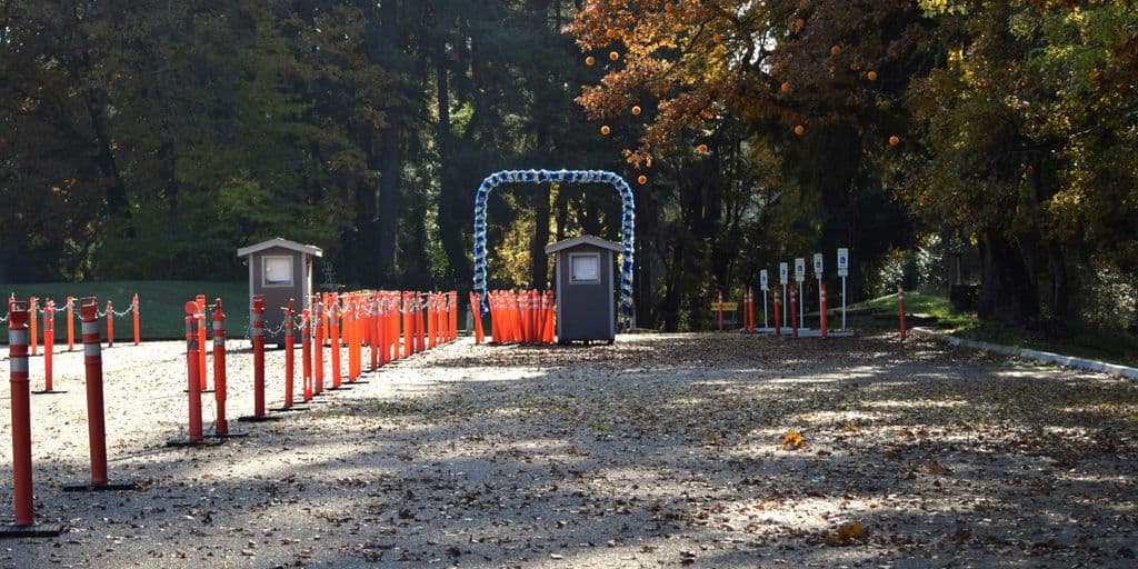 a row of orange and blue barriers in a park